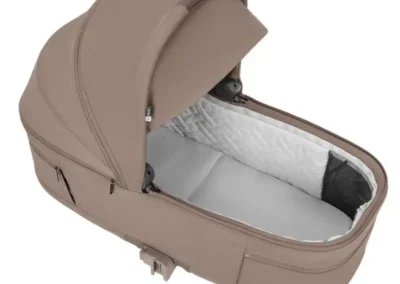 Beige infant carrycot with open hood, showing quilted white lining inside.